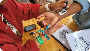 Festival wristbands being applied at event entry